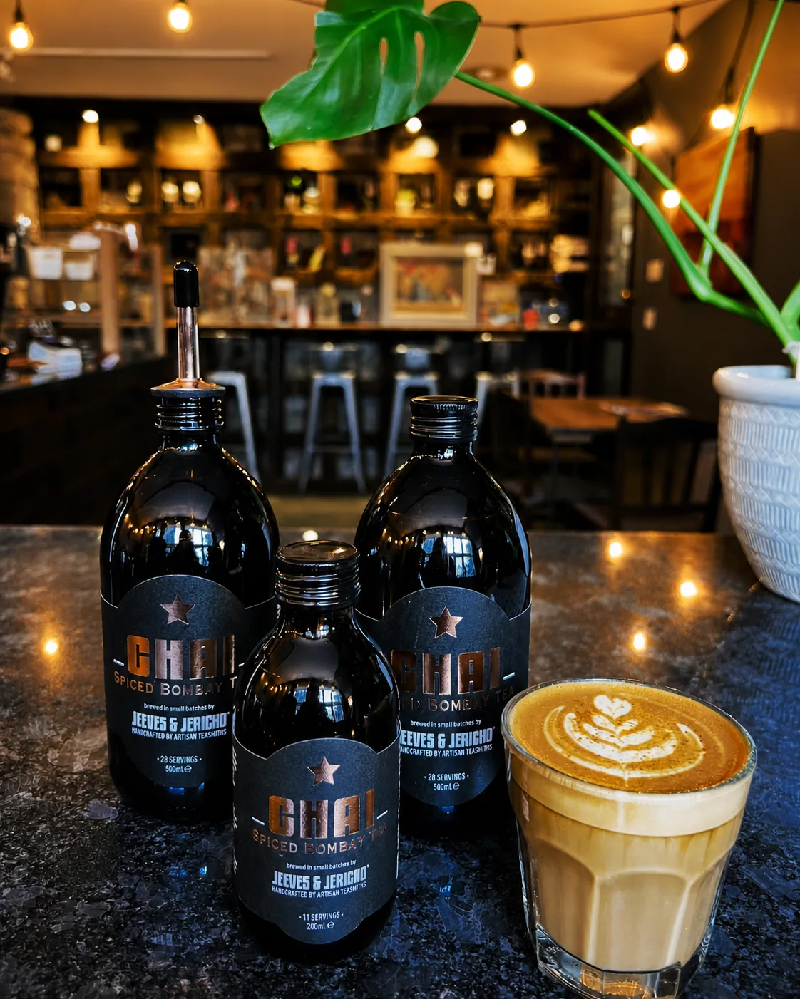Chai tea bottles and a latte at the Gatehouse Coffee counter
